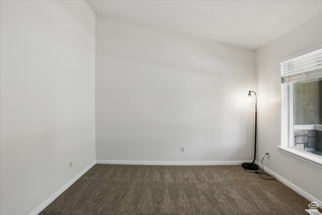 Unfurnished room with carpet and baseboards