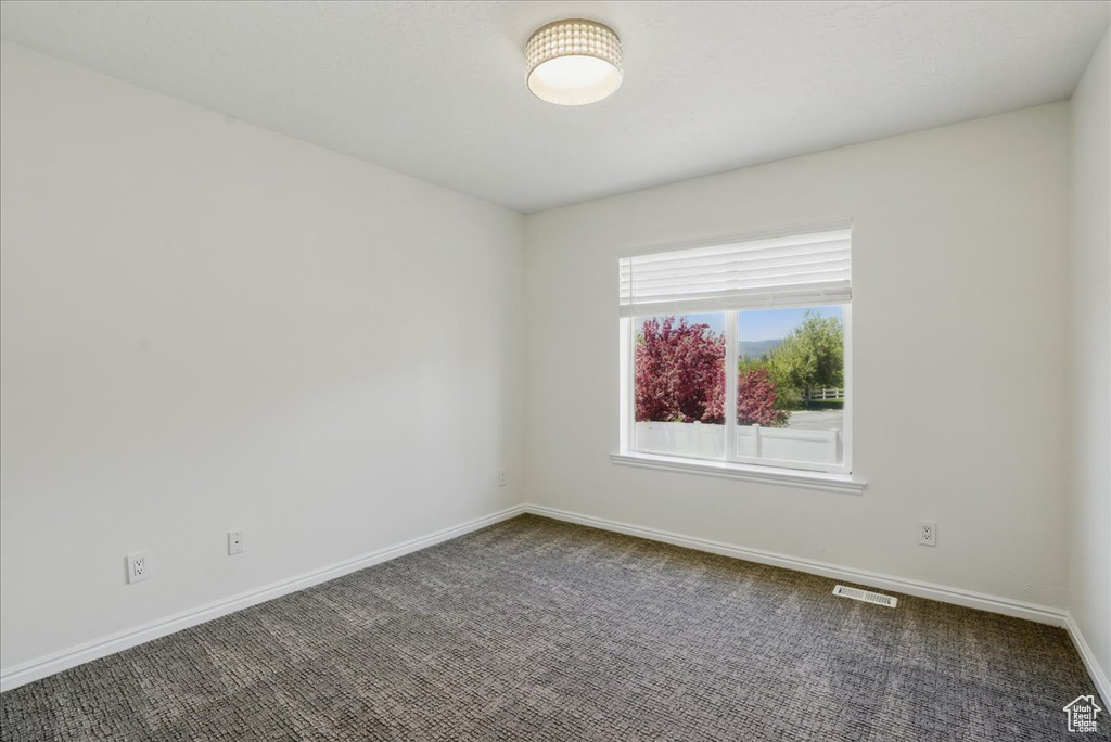 Unfurnished room featuring baseboards and carpet flooring