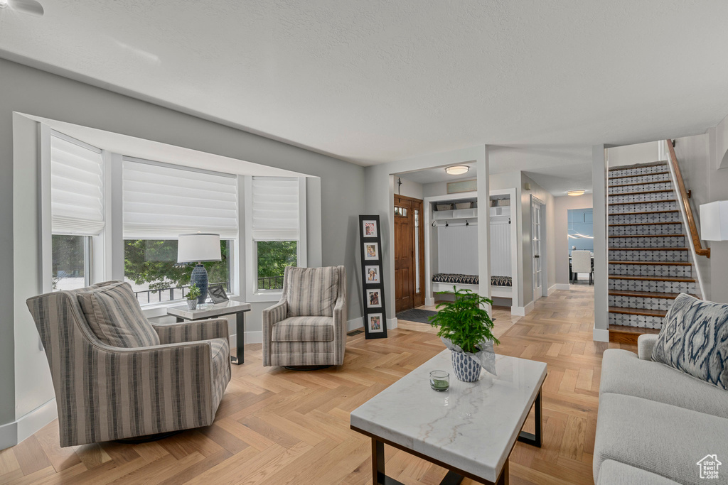 Living area featuring baseboards and stairs