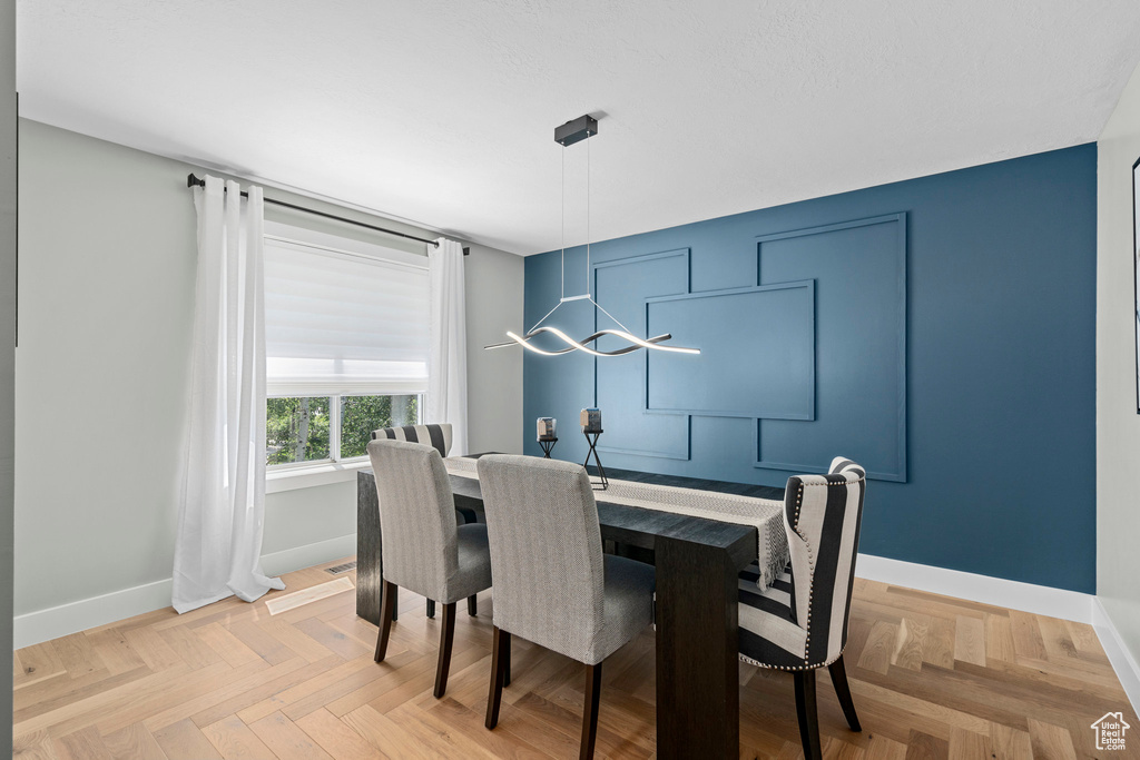 Dining space with a chandelier and baseboards