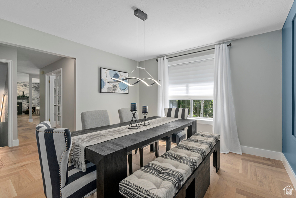 Dining space with baseboards and a chandelier