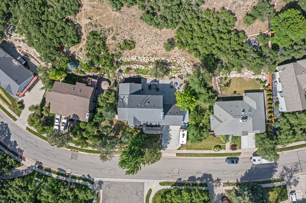 Aerial view of property and surrounding area featuring nearby suburban area