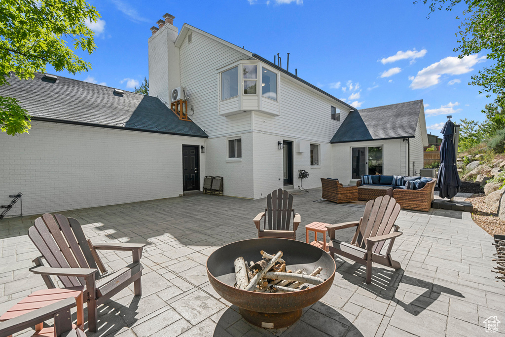 View of patio / terrace with an outdoor living space with a fire pit