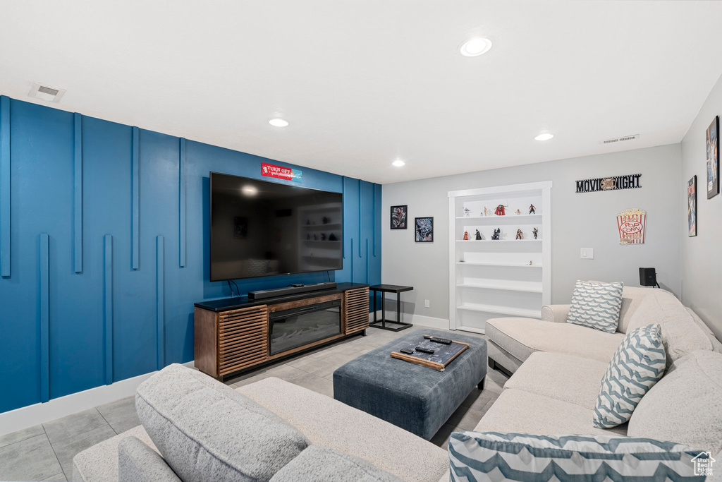 Living area featuring built in shelves, recessed lighting, and baseboards