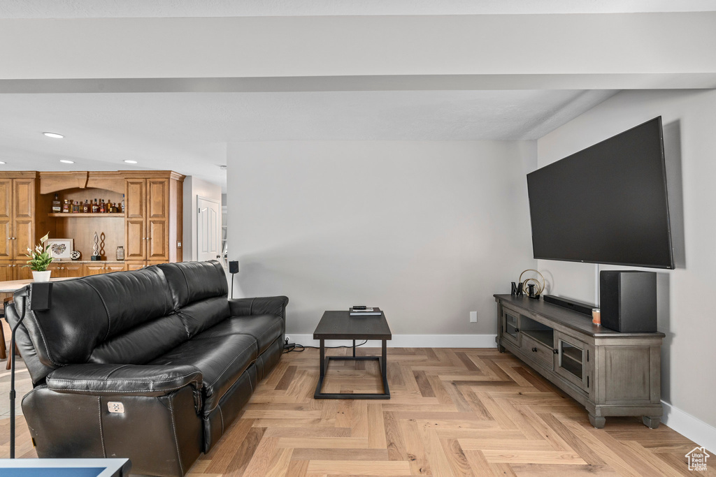 Living room featuring recessed lighting, baseboards, and bar area