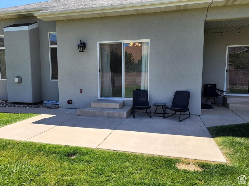 Back of property featuring stucco siding, a patio, and entry steps