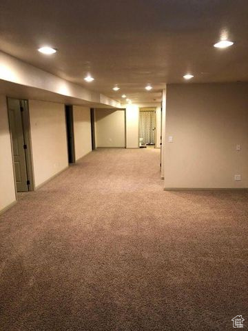 Finished basement featuring light carpet and recessed lighting