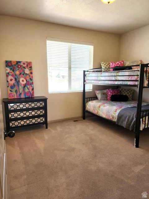Bedroom featuring carpet flooring and baseboards