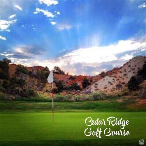 View of community featuring a mountain view, a yard, view of golf course, and a putting area