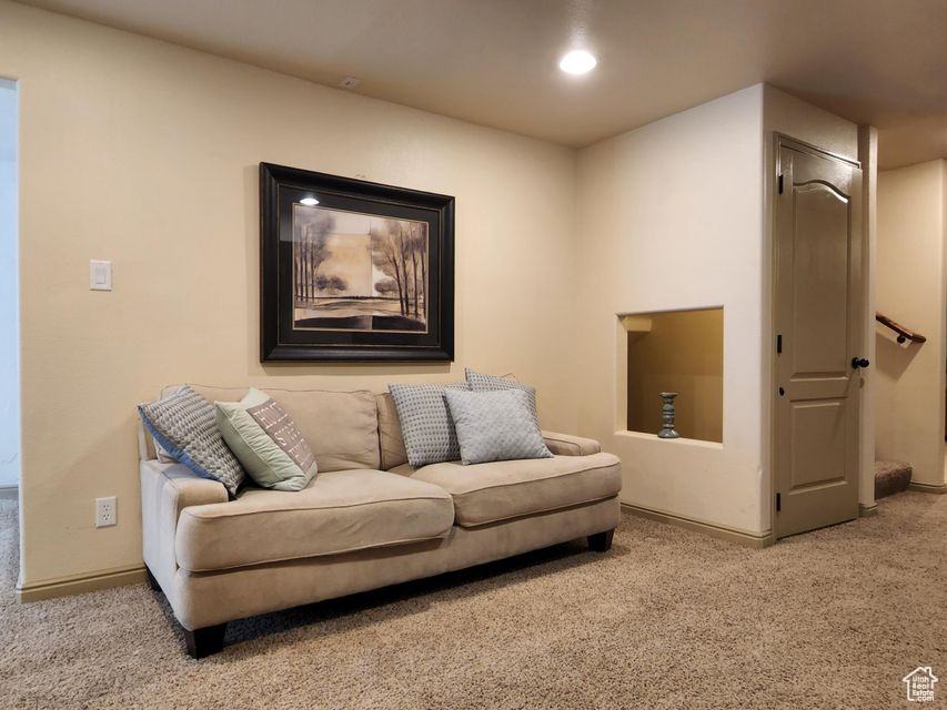 Living room with carpet floors, baseboards, and recessed lighting