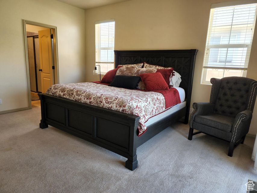 Bedroom featuring light colored carpet