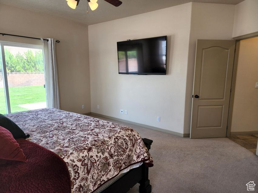 Bedroom with access to outside, carpet floors, baseboards, and ceiling fan
