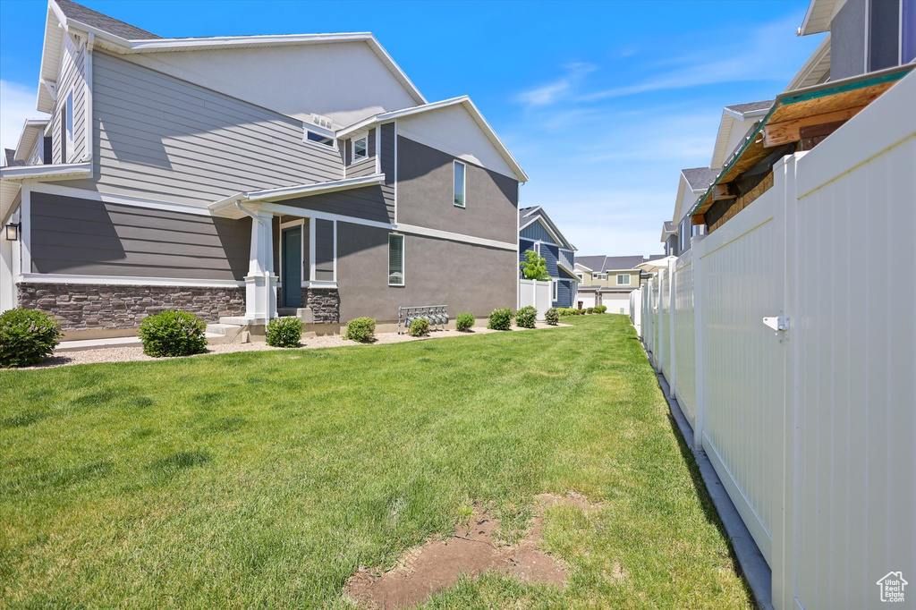 View of side of home with stone siding and a residential view