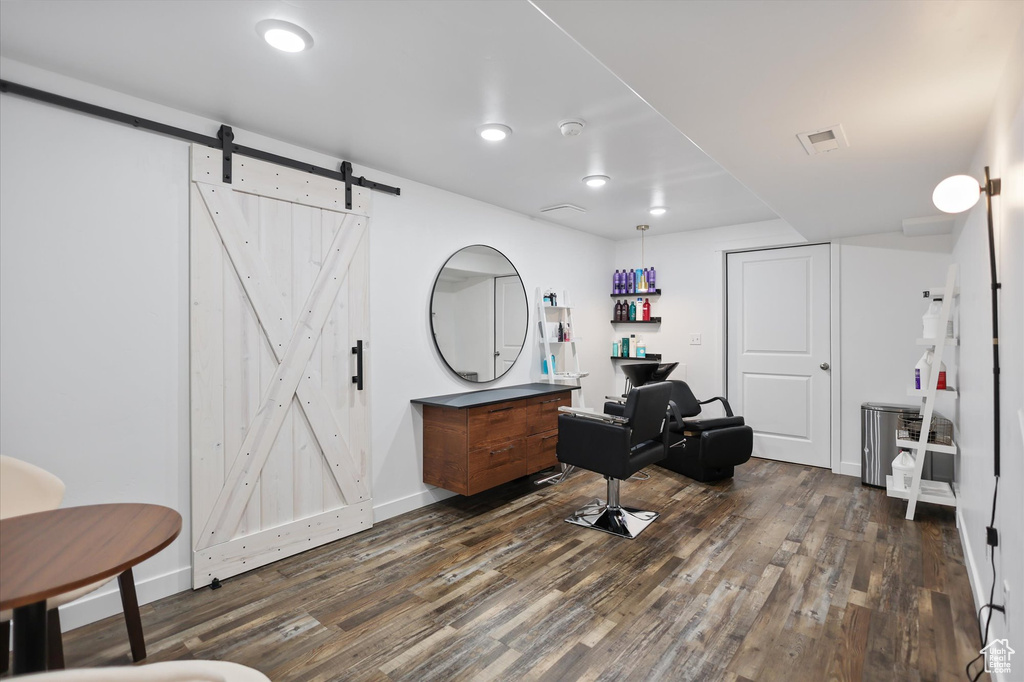 Office area featuring a barn door, dark wood finished floors, baseboards, and recessed lighting