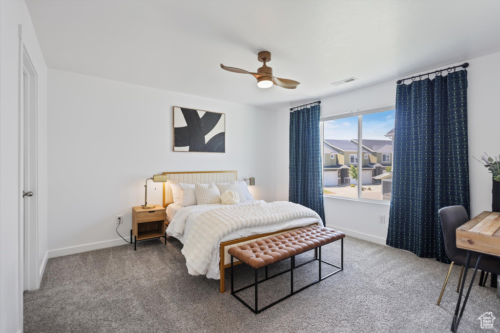 Bedroom with carpet, baseboards, and a ceiling fan