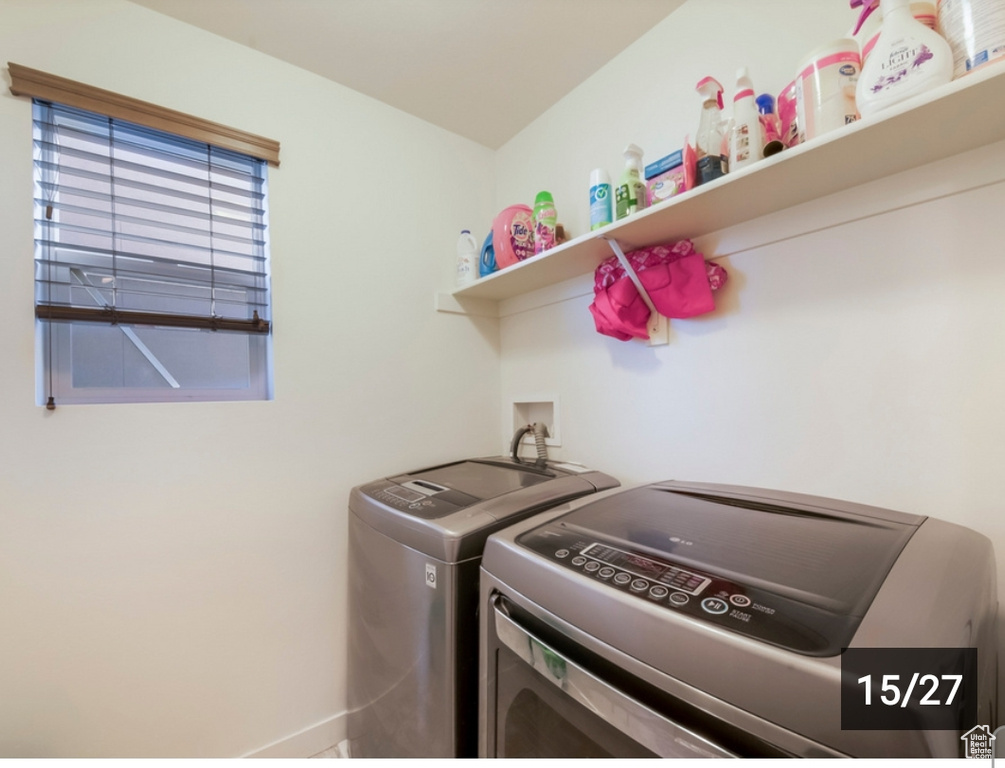 Washroom with independent washer and dryer and baseboards
