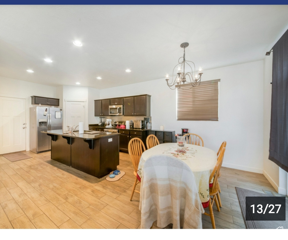 Dining space with light wood-style floors, a chandelier, recessed lighting, and baseboards
