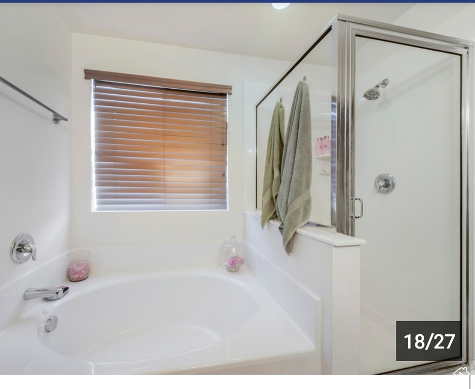 Full bath featuring a shower stall and a bath