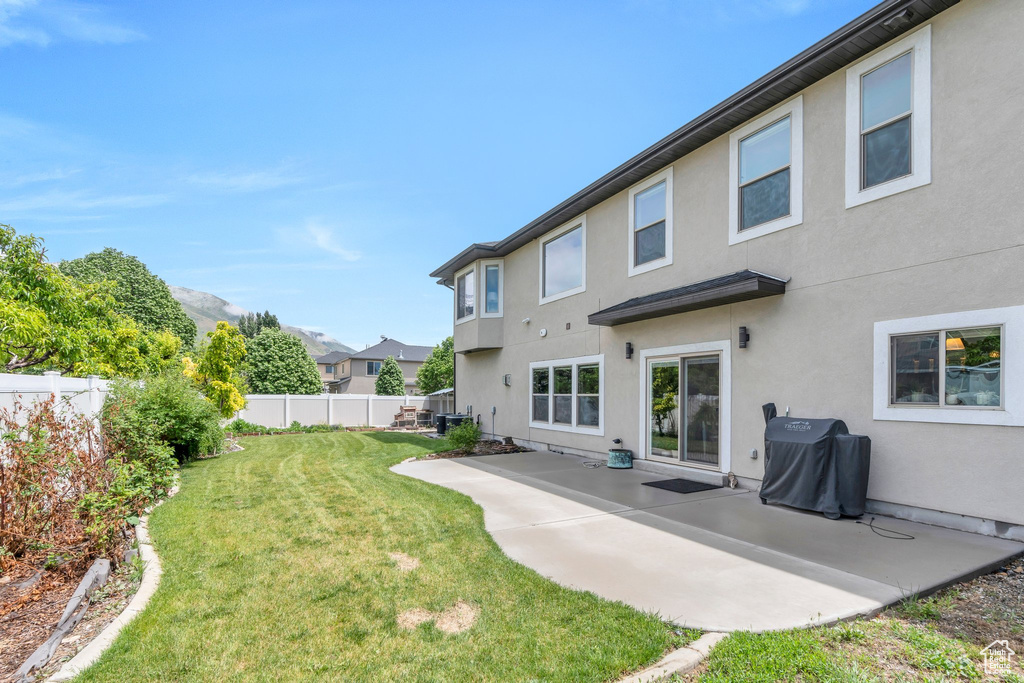 Back of property with stucco siding and a patio area