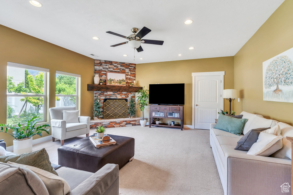 Living room featuring ceiling fan, light carpet, and recessed lighting