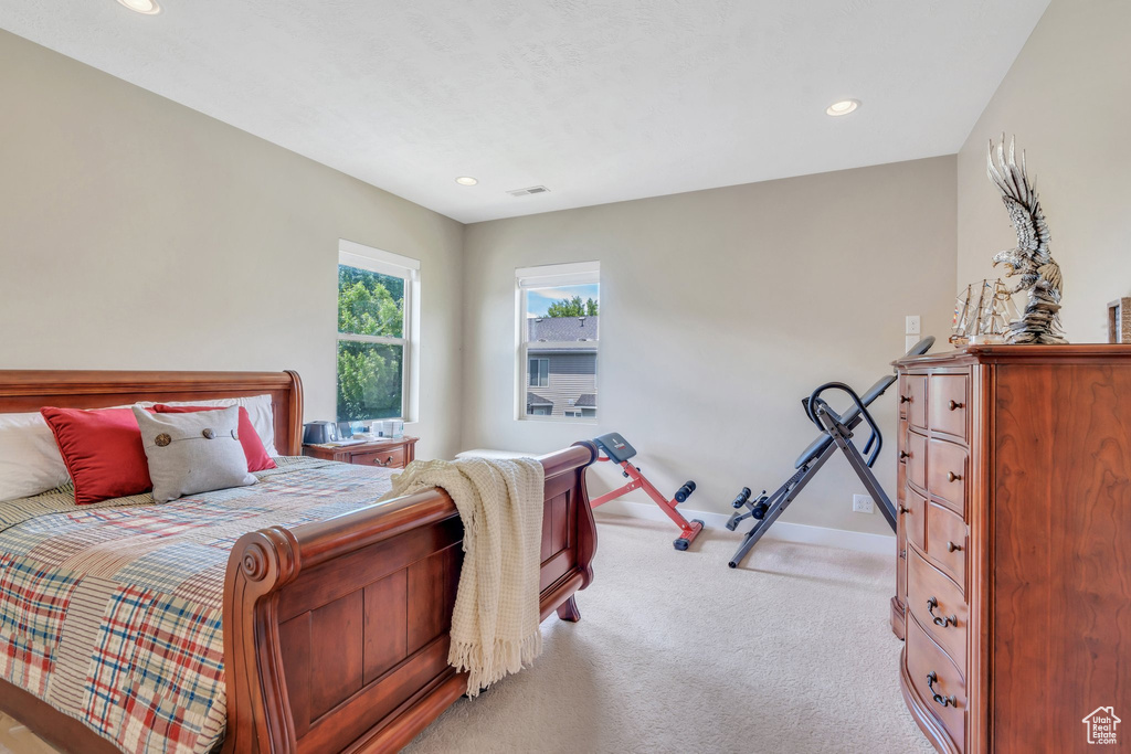 Carpeted bedroom with recessed lighting and baseboards