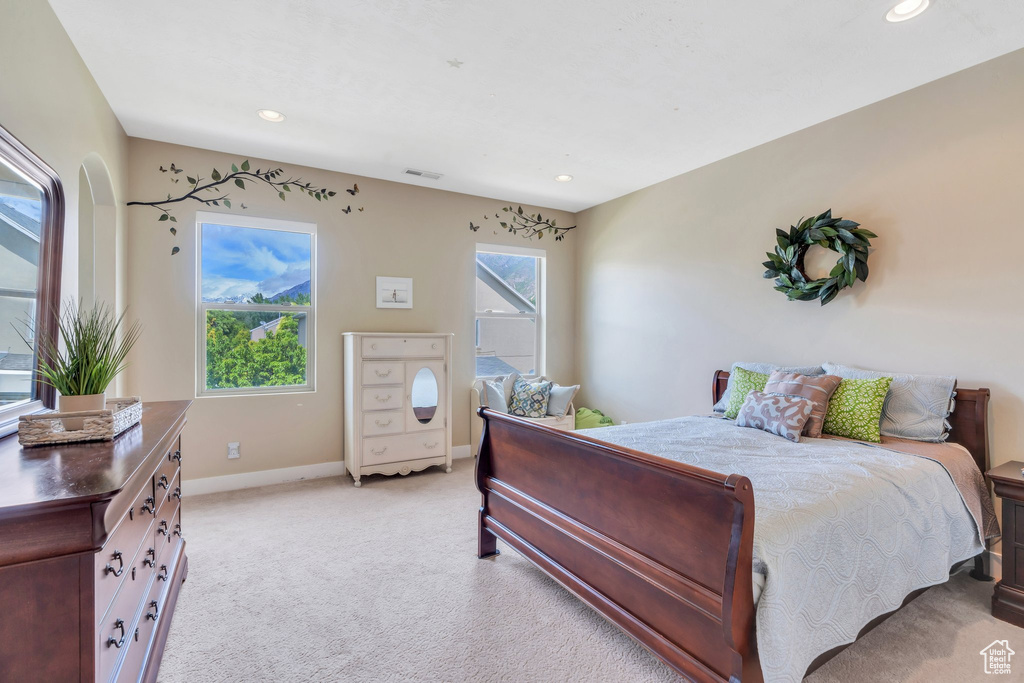 Bedroom featuring light carpet, baseboards, and recessed lighting