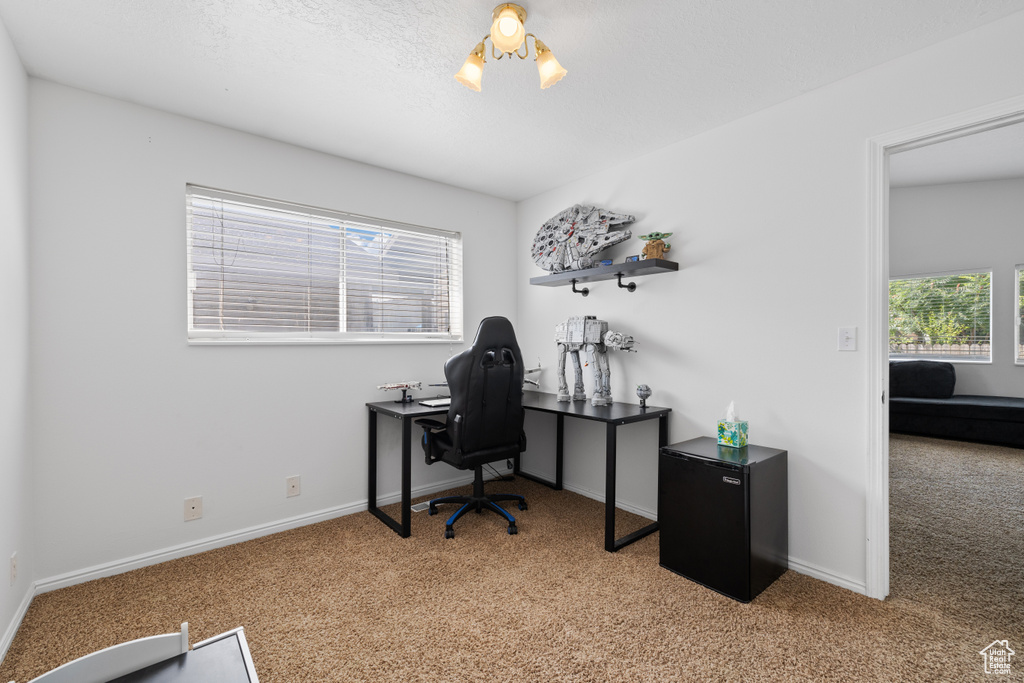 Office area featuring carpet floors and baseboards