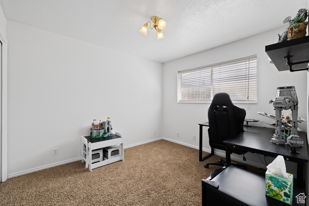 Home office with carpet flooring and baseboards