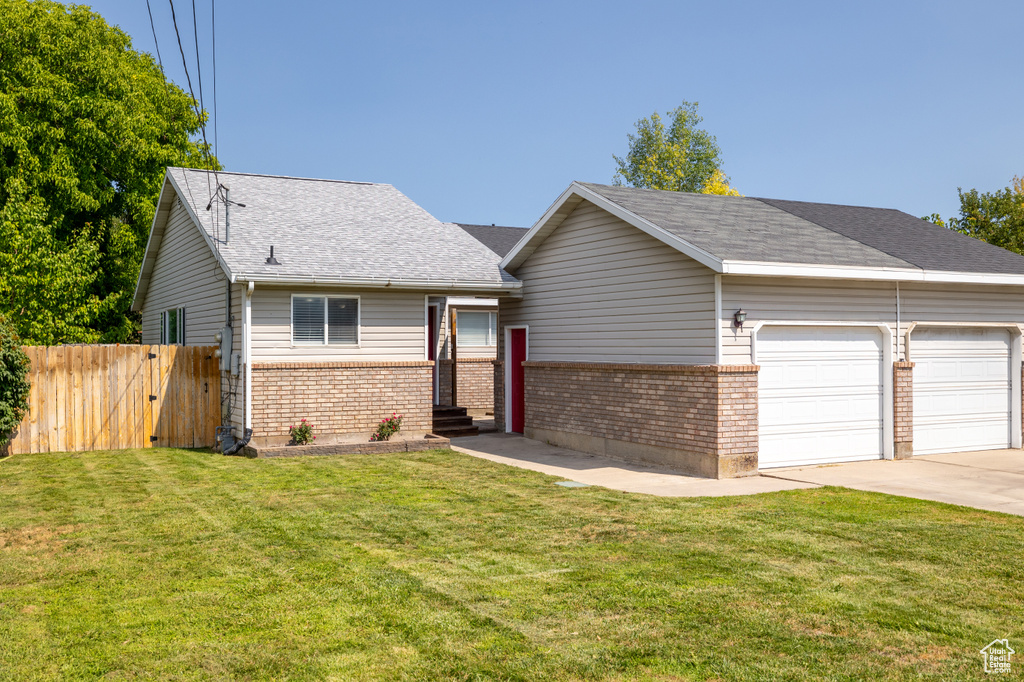 View of front facade featuring brick siding, a garage, concrete driveway, and a shingled roof
