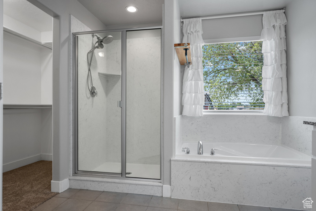 Bathroom with a shower stall, a garden tub, tile patterned floors, a walk in closet, and recessed lighting