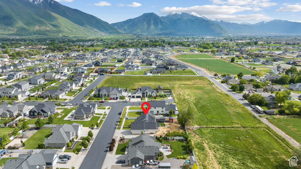 Aerial view of property's location featuring a mountain backdrop and nearby suburban area