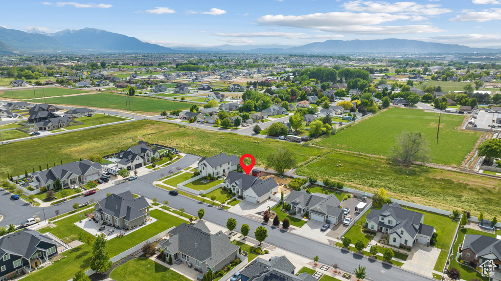 Aerial overview of property's location featuring nearby suburban area and mountains