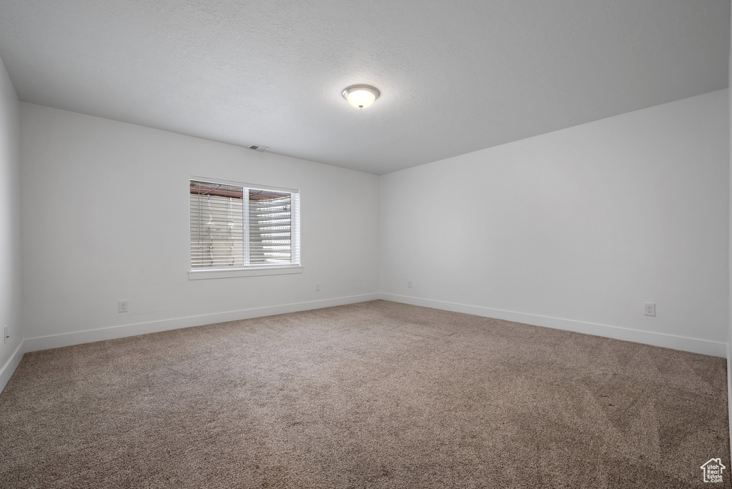 Unfurnished room with baseboards and carpet