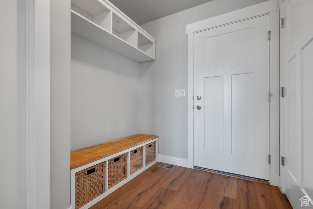 Mudroom with wood finished floors and baseboards