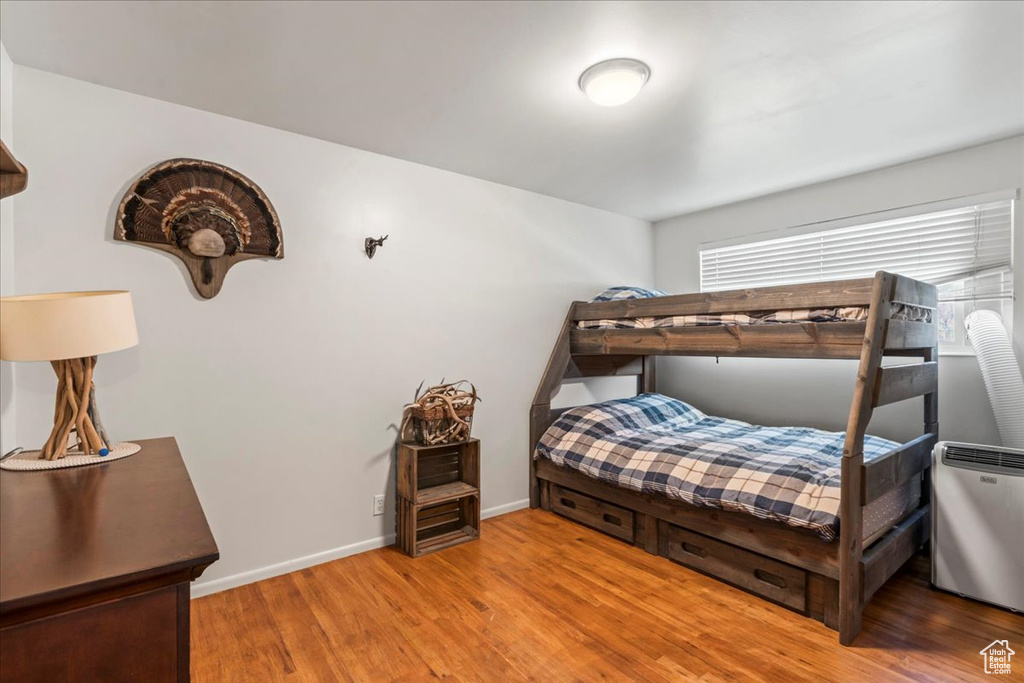 Bedroom featuring light wood-type flooring and baseboards