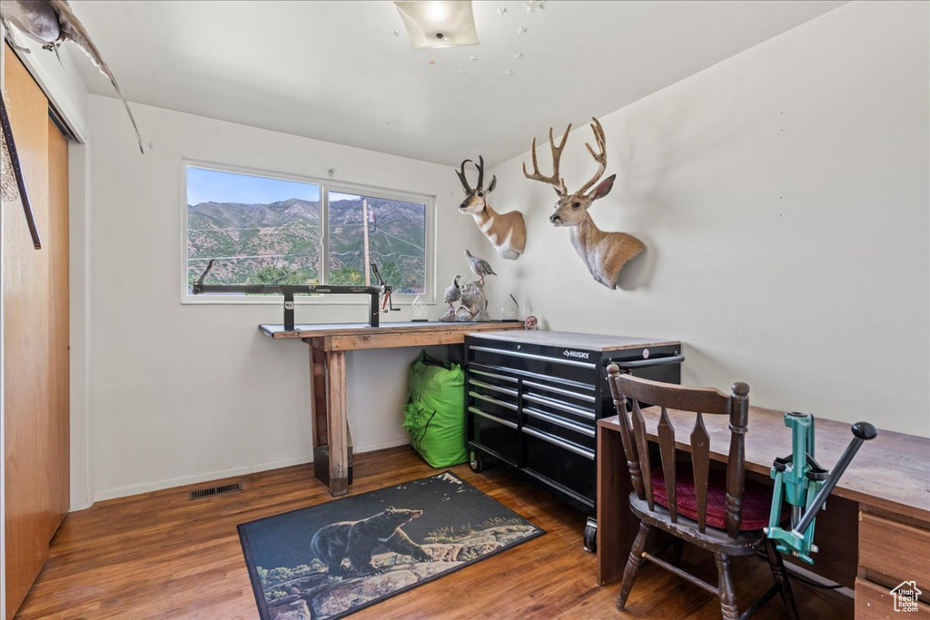 Office with wood finished floors and baseboards