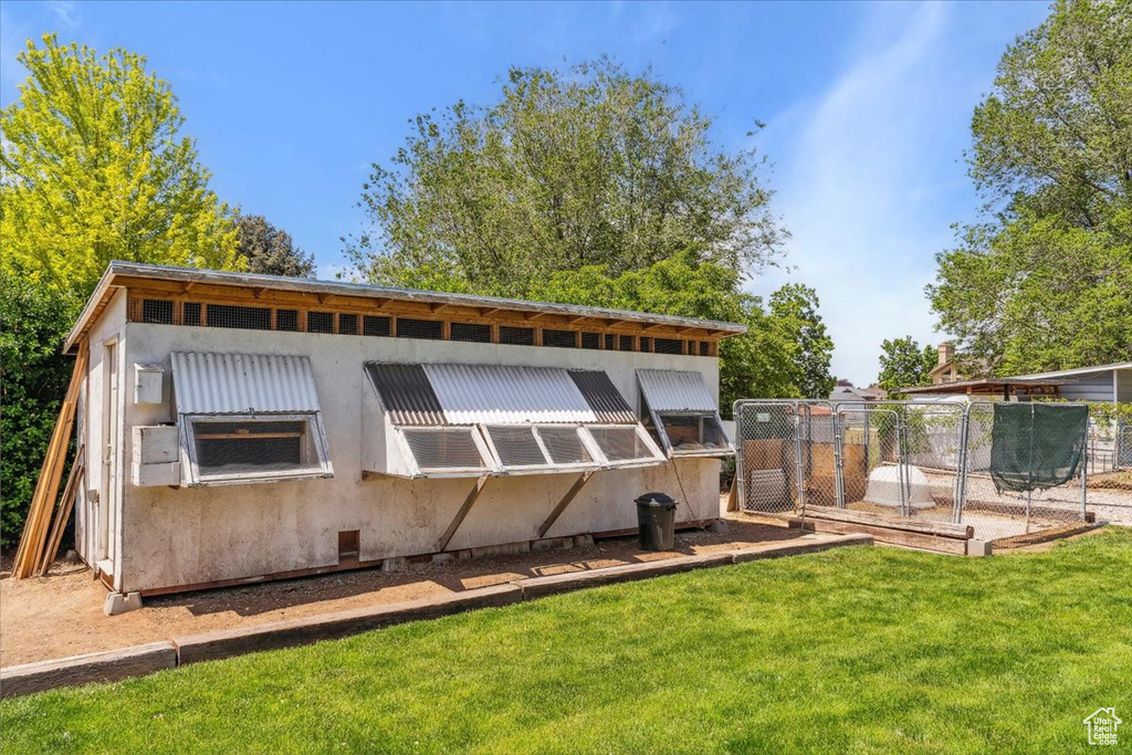 Rear view of property with an outbuilding