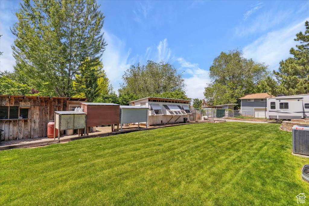 View of yard with central AC unit and exterior structure