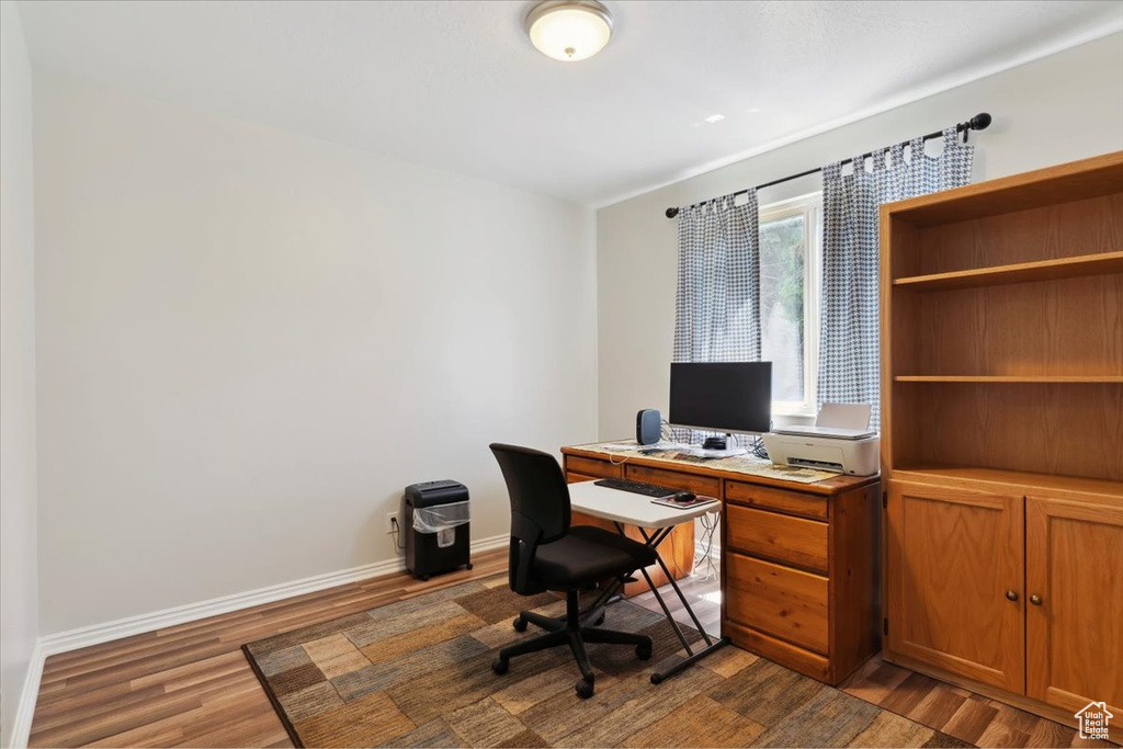 Office space featuring wood finished floors and baseboards