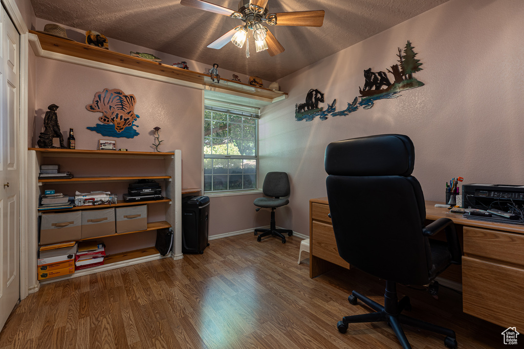 Office with a ceiling fan, wood finished floors, a textured ceiling, and baseboards