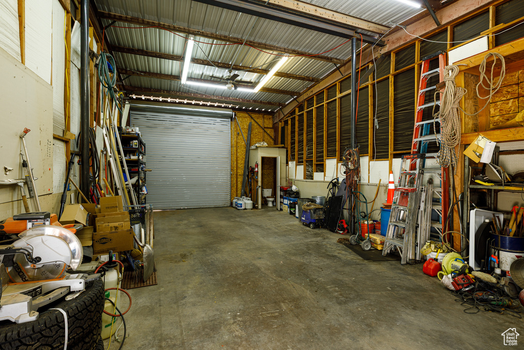 Garage featuring metal wall and a workshop area