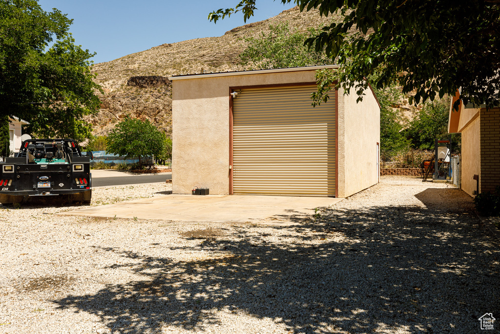 Detached garage with a mountain view and concrete driveway