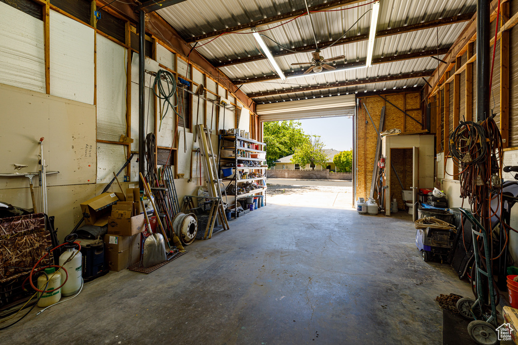 Garage featuring metal wall and a ceiling fan