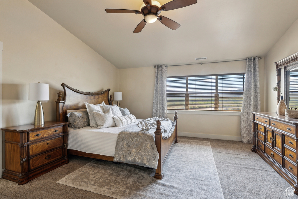 Bedroom with light carpet, lofted ceiling, baseboards, and ceiling fan
