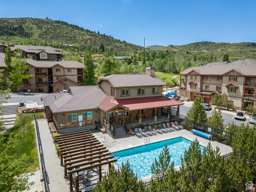 View of pool with a mountain view, a residential view, and a patio