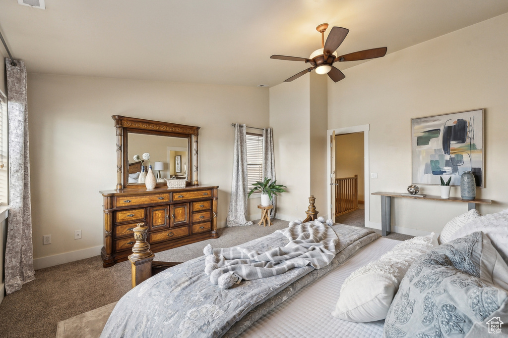 Bedroom with carpet, lofted ceiling, baseboards, and a ceiling fan