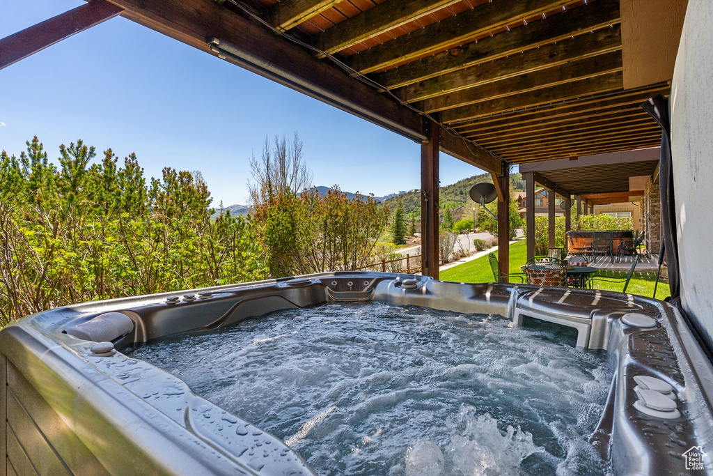 View of patio with a hot tub