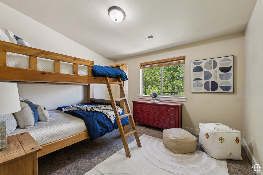Bedroom featuring carpet flooring and baseboards