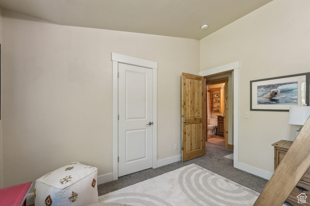 Carpeted bedroom with baseboards