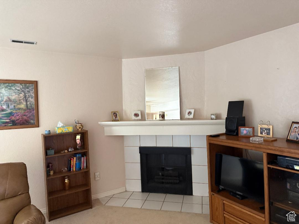 Living room featuring a tile fireplace